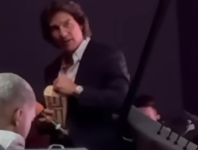 Tom Cruise eating popcorn