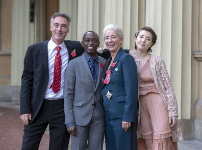LONDON, ENGLAND - NOVEMBER 7: Actress Emma Thompson, with her husband Greg Wise and children Gaia Wise and Tindy Agaba, leaves Buckingham Palace after she received her damehood at an Investiture ceremony on November 7, 2018 in London, England. Ms Thompson, 59, received the accolade in recognition of her services to drama. (Photo by Steve Parsons - WPA Pool/Getty Images)