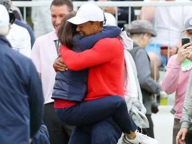 MELBOURNE, AUSTRALIA - DECEMBER 15: Playing Captain Tiger Woods of the United States team celebrates with girlfriend Erica Herman after defeating Abraham Ancer of Mexico and the International team 3&2 during Sunday Singles matches on day four of the 2019 Presidents Cup at Royal Melbourne Golf Course on December 15, 2019 in Melbourne, Australia. (Photo by Warren Little/Getty Images)