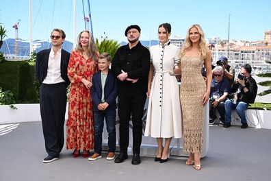 (L-R) Edouard Philipponnat, Kelly B. Eviston, Clark Shotwell, John Travolta, Ella Bleu Travolta and Olga Hoffmann attend the Official Cannes Film Festival Photocall for the Apple Original Film "Propeller One-Way Night Coach" at the rooftop of the Palais des Festival on May 16, 2026 in Cannes, France. "Propeller One-Way Night Coach" premieres globally on Apple TV on Friday, May 29.