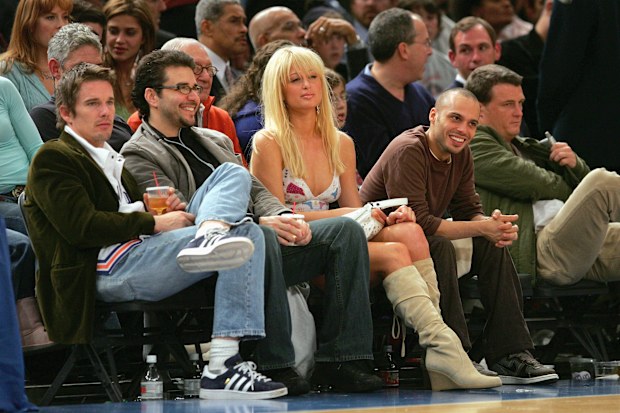 NEW YORK - NOVEMBER 23: Paris Hilton and Ethan Hawke (L) watch game action between the Atlanta Hawks and the New York Knicks on November 23, 2004 at Madison Square Garden in New York City, New York. The Knicks defeated the Hawks 104-88. NOTE TO USER: User expressly acknowledges and agrees that, by downloading and/or using this Photograph, user is consenting to the terms and conditions of the Getty Images License Agreement. (Photo by Ezra Shaw/Getty Images) *** Local Caption *** Paris Hilton